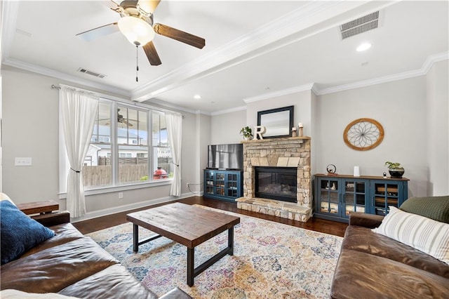 living room featuring dark wood-type flooring, visible vents, crown molding, and baseboards