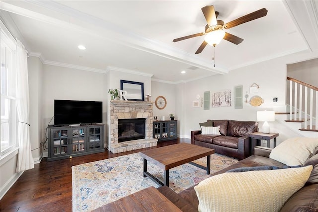 living area featuring baseboards, ornamental molding, dark wood-style flooring, stairs, and a fireplace