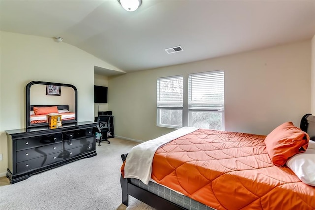 carpeted bedroom with lofted ceiling, visible vents, and baseboards