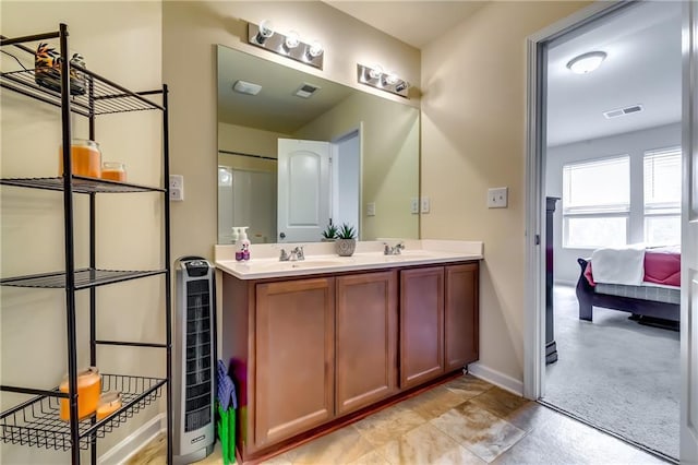 ensuite bathroom with double vanity, wine cooler, visible vents, and a sink