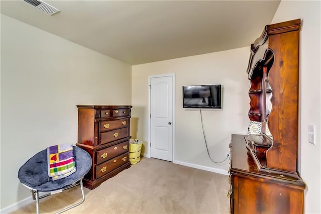 living area with carpet flooring, visible vents, and baseboards