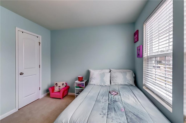 bedroom featuring carpet floors and baseboards