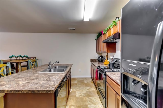 kitchen featuring visible vents, a kitchen island with sink, a sink, under cabinet range hood, and black appliances