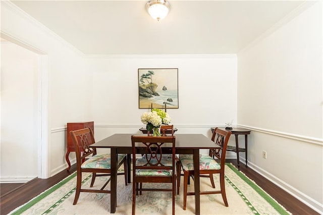 dining space featuring hardwood / wood-style flooring and ornamental molding