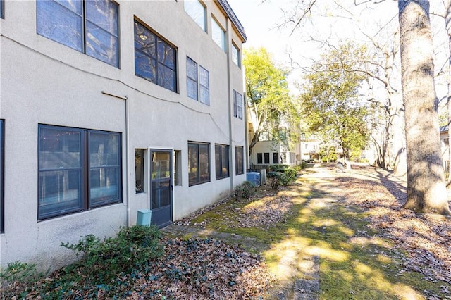 view of side of home with central AC unit