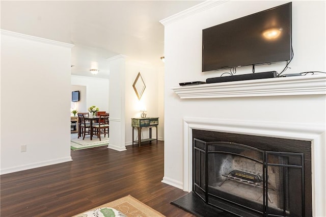 living room featuring dark hardwood / wood-style flooring and crown molding