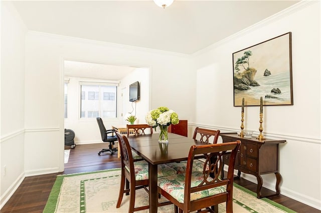 dining area featuring dark wood-type flooring and ornamental molding