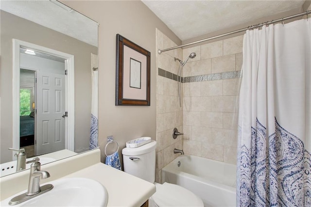 full bathroom with vanity, shower / bath combo, a textured ceiling, and toilet