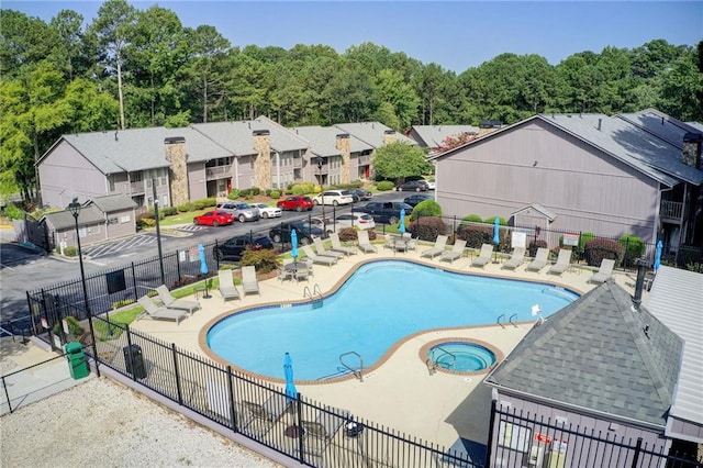 view of swimming pool with a community hot tub and a patio area