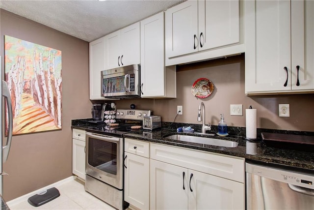 kitchen with white cabinetry, stainless steel appliances, and sink