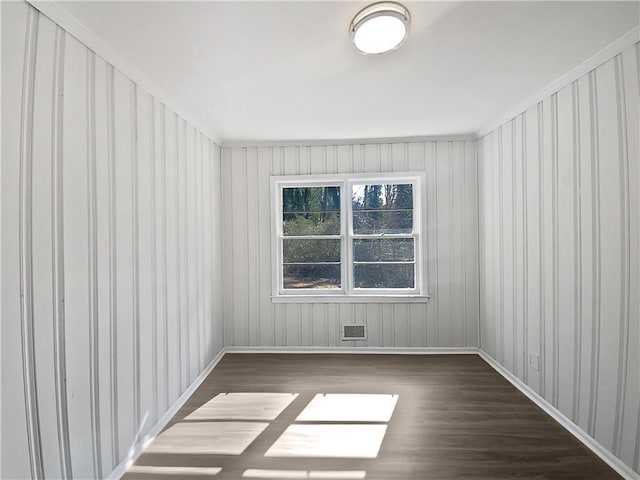 spare room featuring dark wood-type flooring