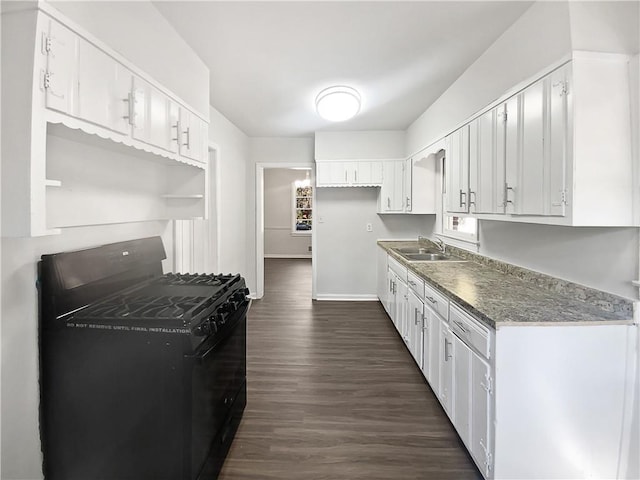 kitchen featuring white cabinetry, sink, dark hardwood / wood-style floors, and gas stove