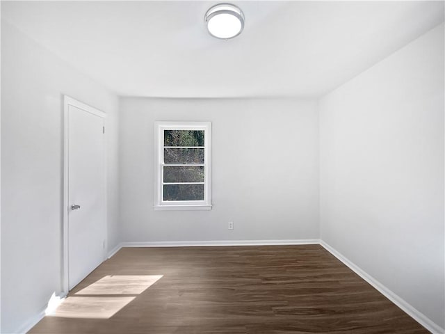 empty room with dark hardwood / wood-style floors