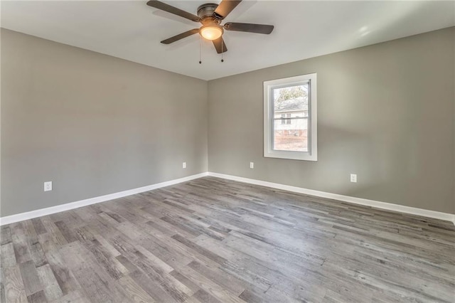 unfurnished room with light wood-style floors, baseboards, and a ceiling fan