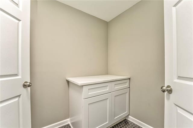 laundry room with baseboards