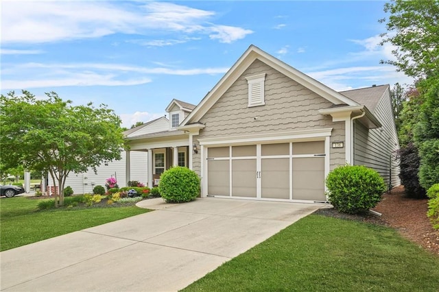 view of front of home with an attached garage, a front lawn, and concrete driveway