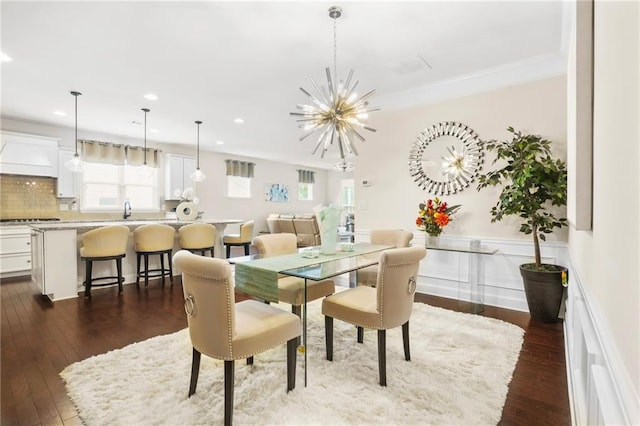 dining space featuring dark wood-style flooring, a notable chandelier, plenty of natural light, and recessed lighting