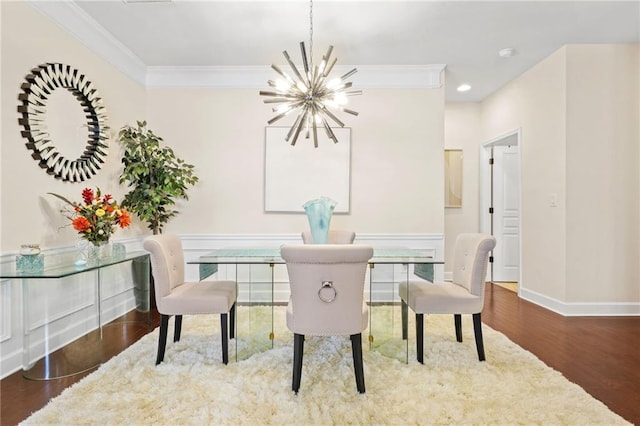 dining space featuring crown molding, wood finished floors, baseboards, an inviting chandelier, and recessed lighting