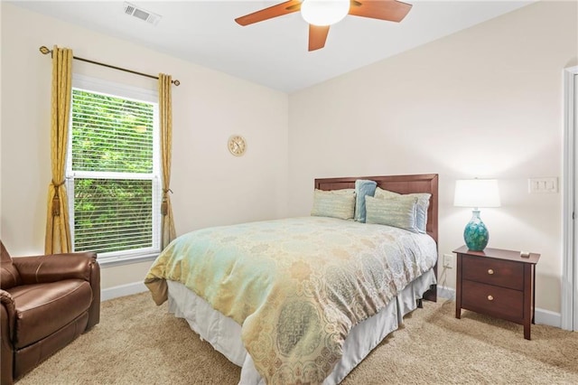 carpeted bedroom featuring baseboards, ceiling fan, and visible vents