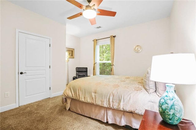 carpeted bedroom featuring a ceiling fan, baseboards, and visible vents