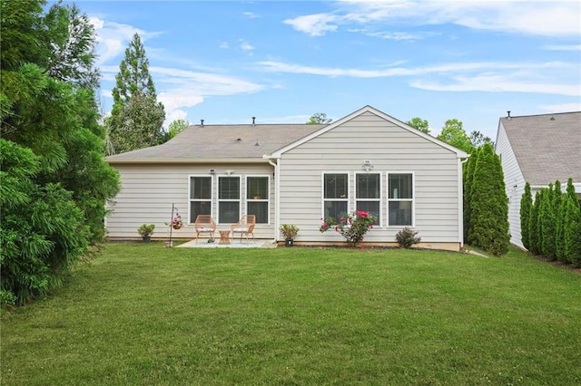rear view of house with a lawn and a patio area