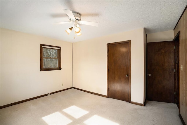 unfurnished bedroom with light carpet, baseboards, and a closet