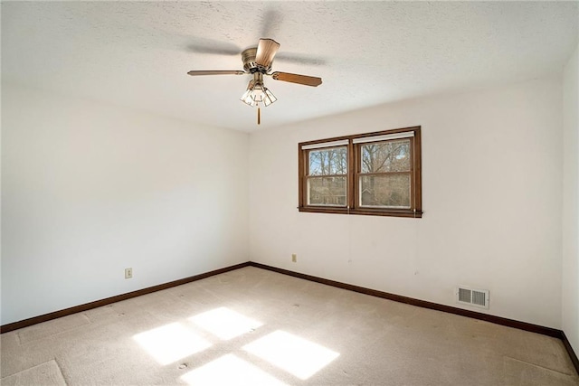 empty room with light colored carpet, baseboards, and ceiling fan