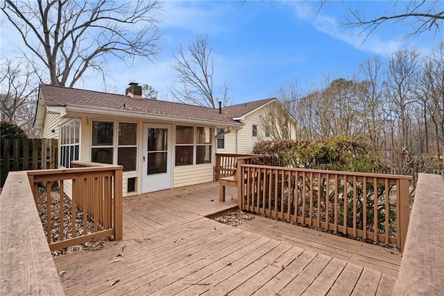 wooden terrace featuring a sunroom and fence