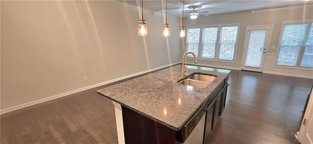 kitchen with a ceiling fan, pendant lighting, dark wood finished floors, a sink, and open floor plan