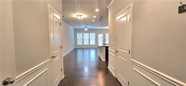 hall with dark wood-style floors and recessed lighting