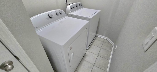 laundry area with light tile patterned floors and independent washer and dryer