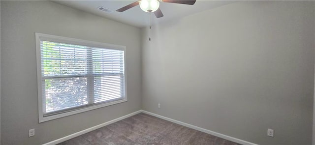 unfurnished room with plenty of natural light, baseboards, a ceiling fan, and visible vents