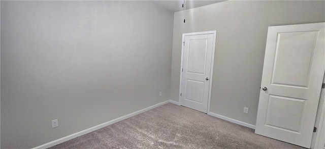 unfurnished bedroom with carpet floors and baseboards