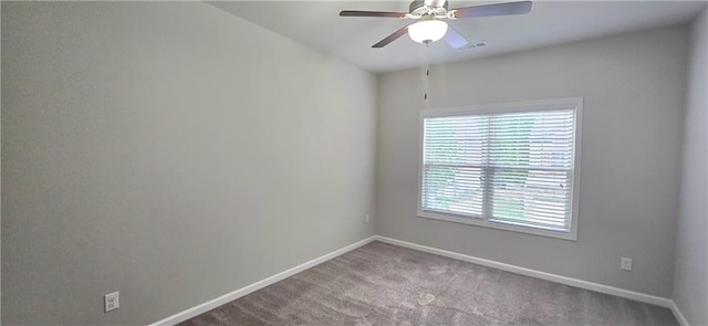 spare room featuring a ceiling fan, carpet flooring, a healthy amount of sunlight, and visible vents
