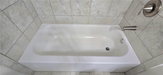 bathroom with a tub to relax in