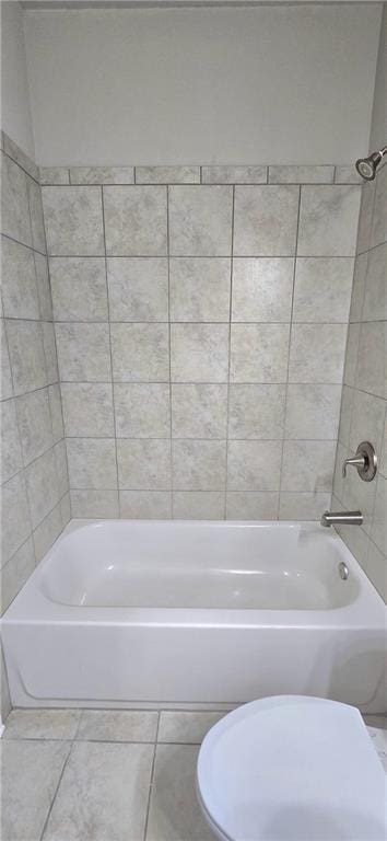 full bathroom featuring shower / bathing tub combination, tile patterned flooring, and toilet