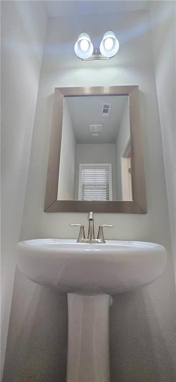 bathroom with visible vents and a sink