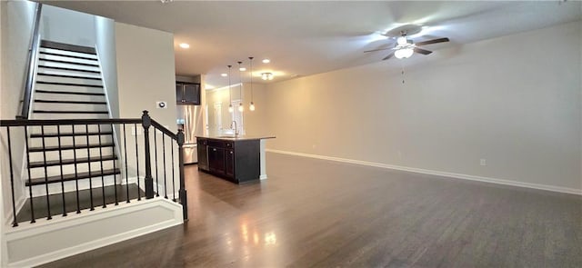 unfurnished room with a ceiling fan, recessed lighting, baseboards, dark wood-style flooring, and stairs