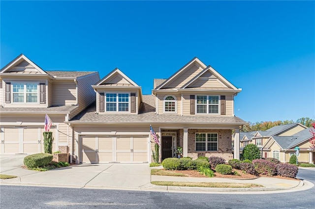 view of front of property featuring concrete driveway, brick siding, and an attached garage