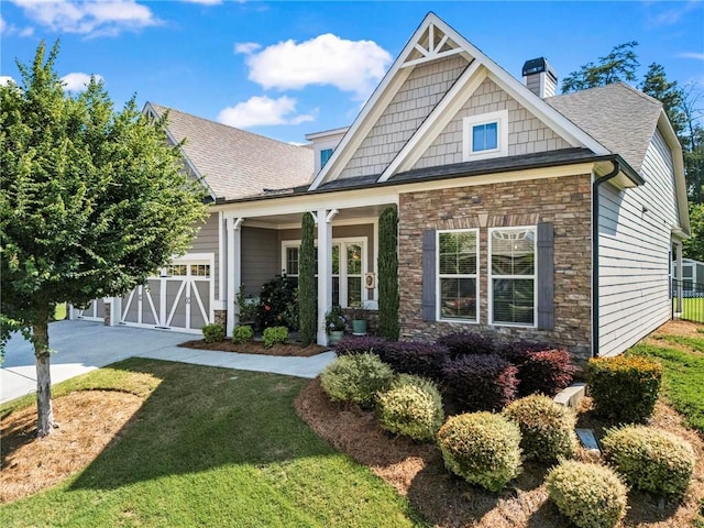 105 Laurel Canyon Trl, Canton, GA 30114 - craftsman inspired home with stone siding, a chimney, driveway, a garage, and a shingled roof