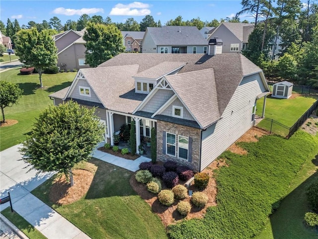 105 Laurel Canyon Trl, Canton, GA 30114 - view of front of home featuring stone siding, a residential view, roof with shingles, and a storage shed