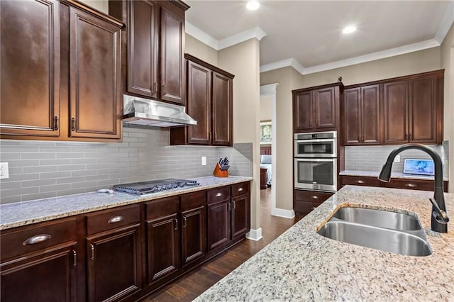 105 Laurel Canyon Trl, Canton, GA 30114 - kitchen featuring stainless steel appliances, under cabinet range hood, dark wood-type flooring, light stone counters, and backsplash