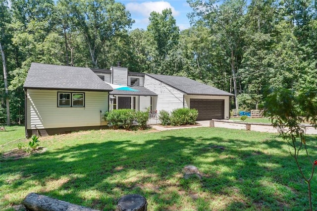 view of front of house with a garage and a front lawn