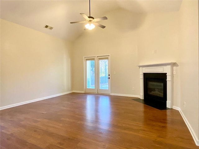 unfurnished living room featuring visible vents, ceiling fan, baseboards, dark wood finished floors, and a fireplace with flush hearth