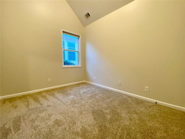 unfurnished room featuring visible vents, carpet, baseboards, and high vaulted ceiling