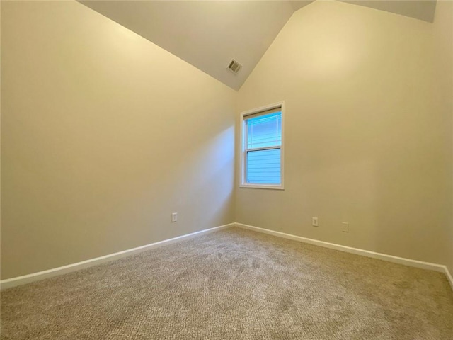 carpeted spare room with visible vents, baseboards, and high vaulted ceiling