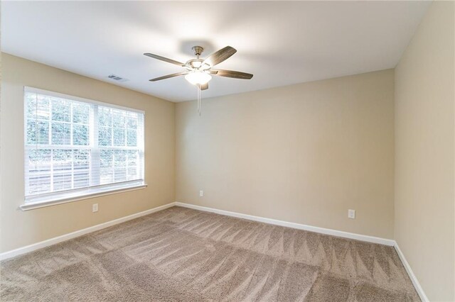 unfurnished room with ceiling fan and carpet floors