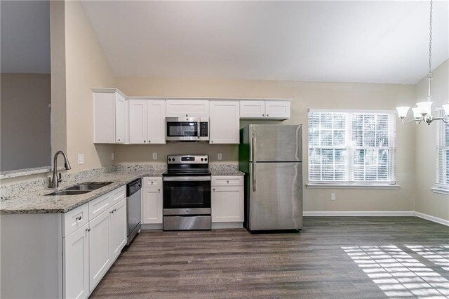 kitchen with pendant lighting, dark hardwood / wood-style floors, white cabinetry, and appliances with stainless steel finishes