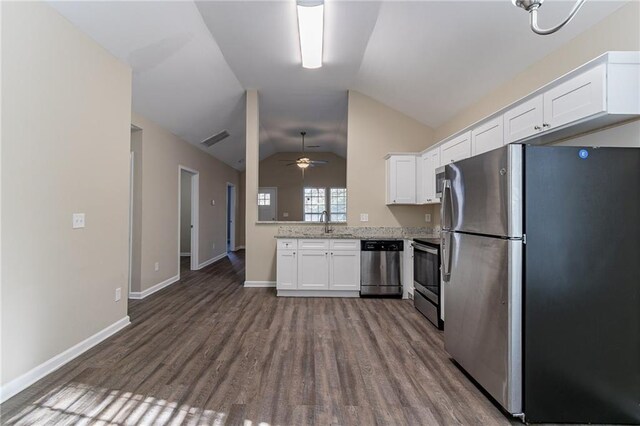 kitchen featuring vaulted ceiling, ceiling fan, appliances with stainless steel finishes, dark hardwood / wood-style flooring, and white cabinetry