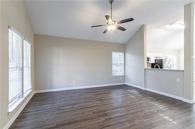 unfurnished room with ceiling fan, dark hardwood / wood-style flooring, and lofted ceiling